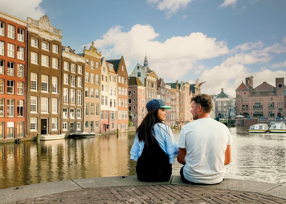 photo-of-couple-sitting-by-canal-after-taking-truffles-in-the-Netherlands