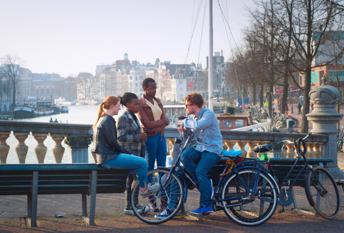 photo-of-students-in-the-netherlands-sitting-on-a-bench-in-amsterdam