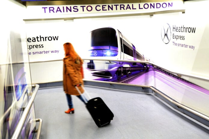 photo-woman-with-trolly-arriving-in-heathrow-airport-headed-for-the-train-station