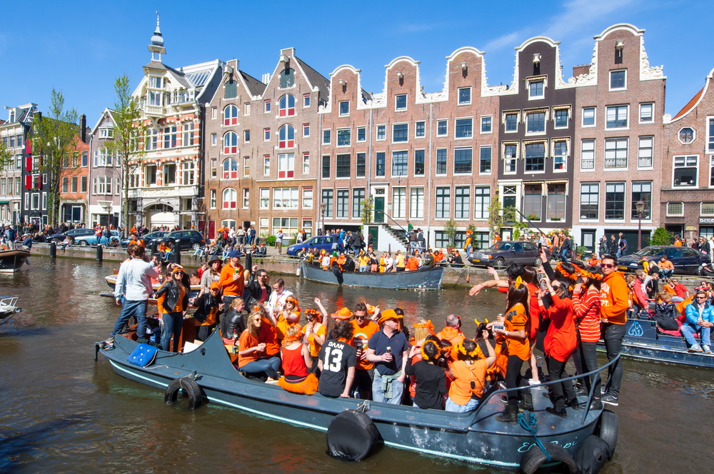 Quirky-Dutch-people-wearing-orange-on-boat-in-Amsterdam-on-King's-day