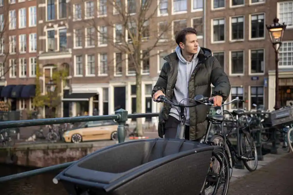 Foto de homem com bakfiets-bike-with-bike-seguro-em-amsterdam