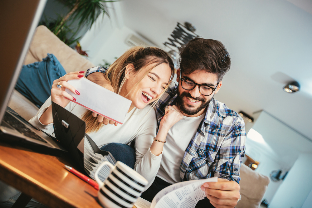 Photo-of-couple-smiling-doing-taxes-after-getting-a-dutch-mortgage