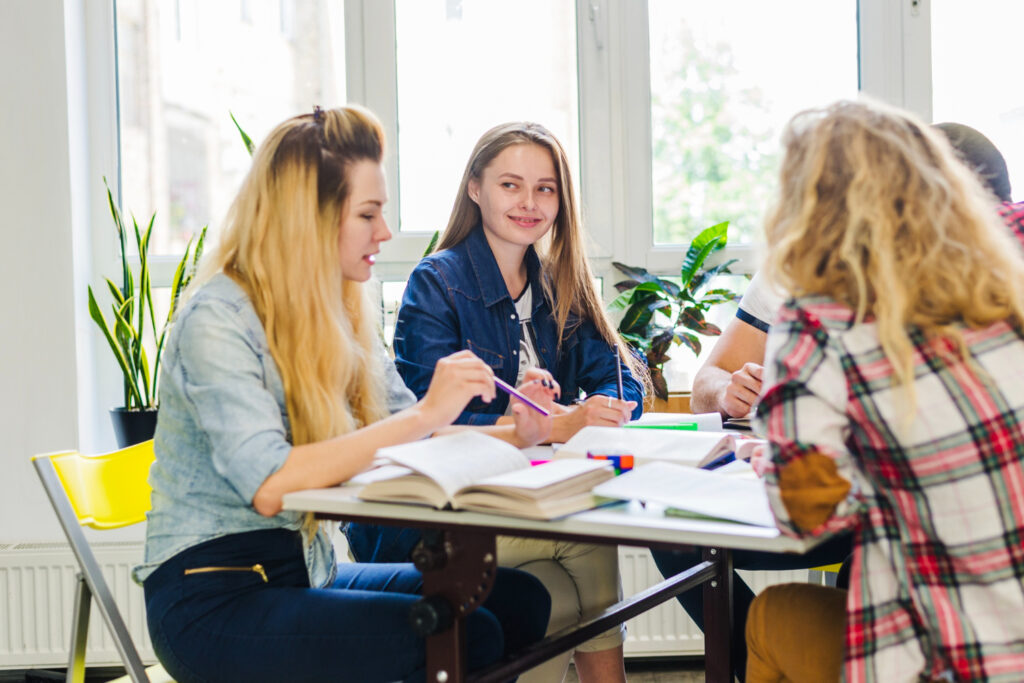 photo-of-students-of-Dutch-Courses-Amsterdam-sitting-around-table-discussing-Dutch-vocab