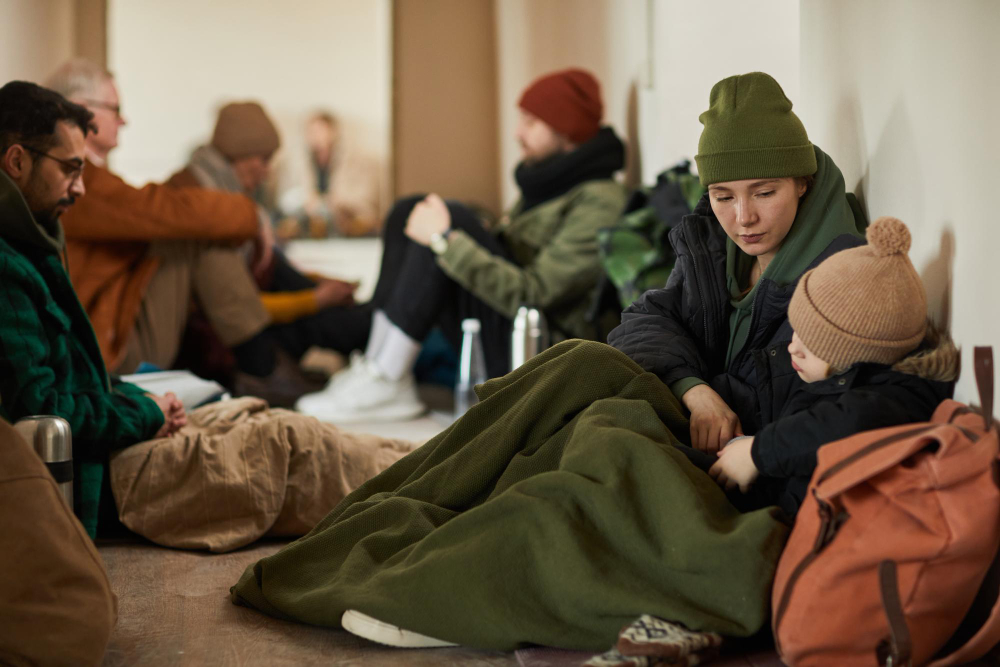 photo-of-refugees-at-asylum-centre-sitting-on-floor-in-Netherlands-during-Dutch-asylum-reception-crisis