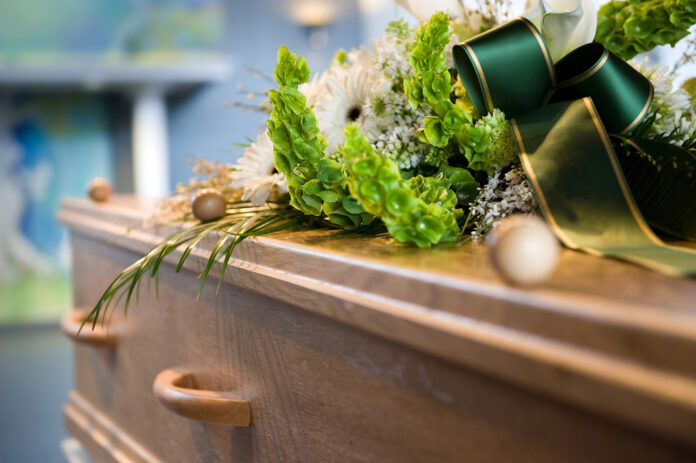 Photo-of-coffin-with-flowers-on-top