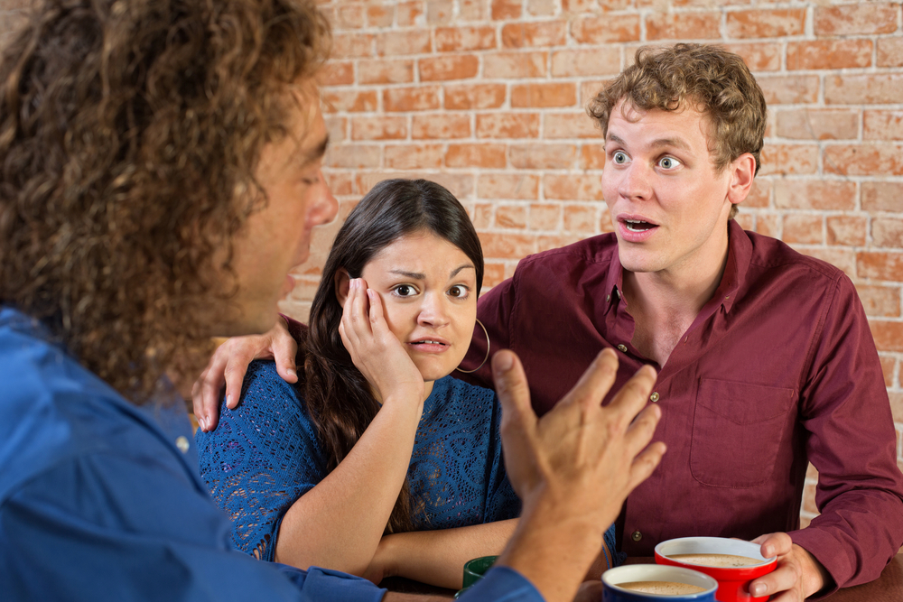 Photo-of-couple-looking-surprised-over-coffee