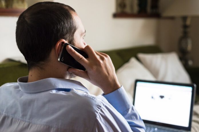 man-on-the-phone-sitting-indoors