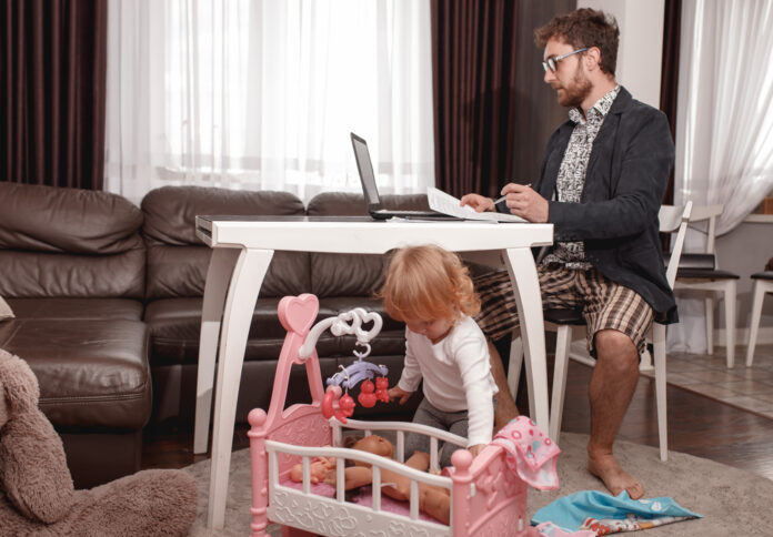 photo-of-man0working-from-home-in-his-underwear-while-taking-care-of-his-child-avoiding-the-office