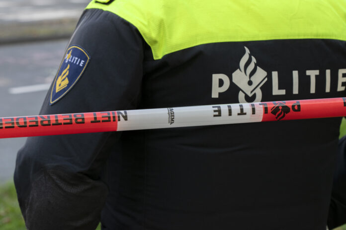 Close-up-of-Dutch-police-agent-standing-behind-ducktape-after-accident