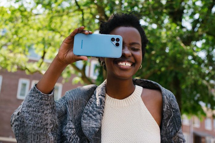 photo-of-woman-smiling-with-phone-in-front-of-her-face