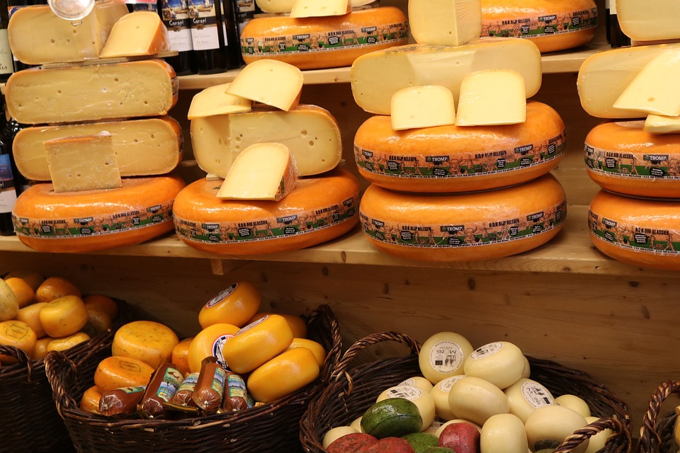 photo-of-whole-and-quartered-gouda-wheels-in-baskets-and-on-shelves