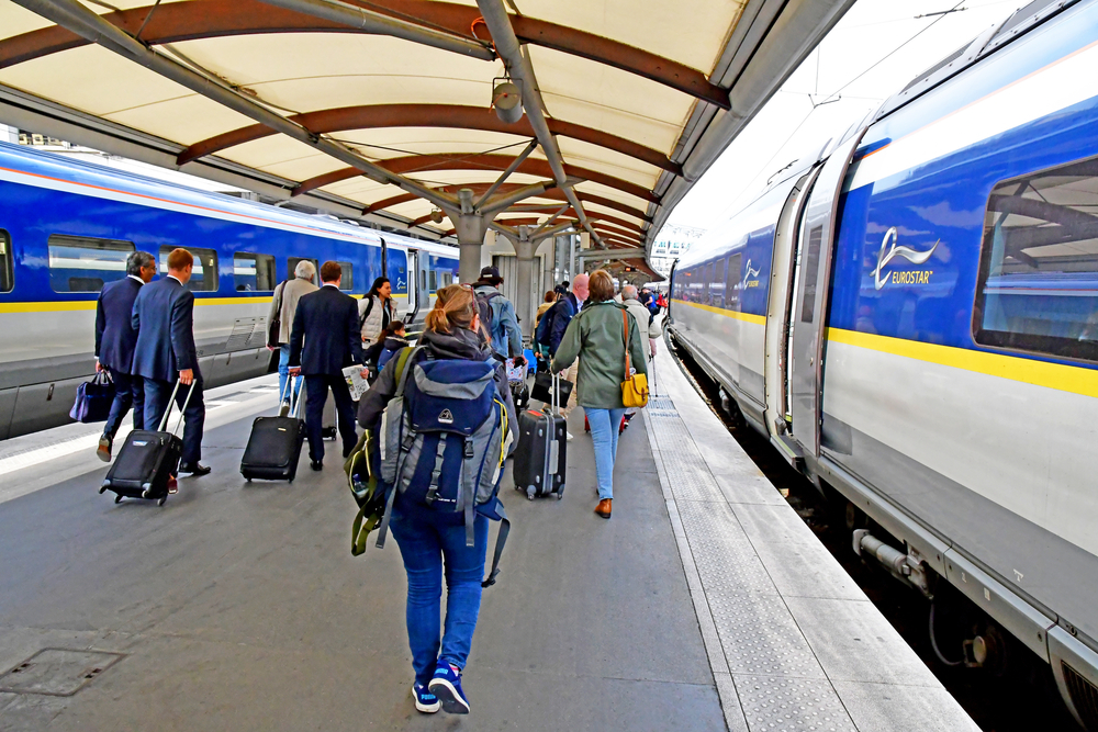 photo-of-people-with-bags-at-a-train-station-next-to-a-eurostar-train-getting-ready-for-their-trip