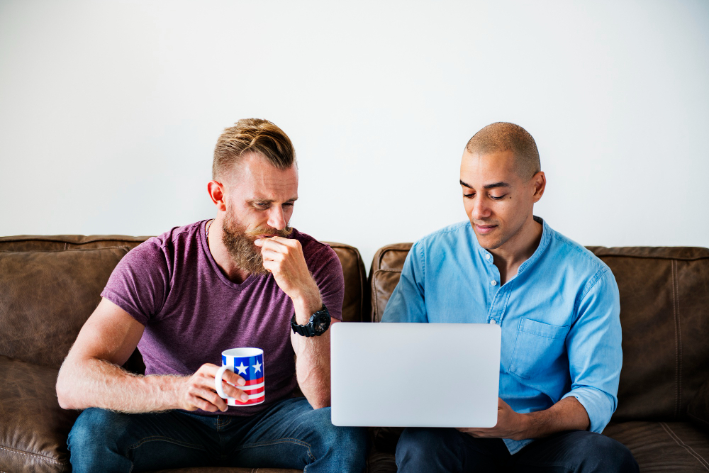 Photo-of-men-looking-at-laptop-considering-what-to-bid-on-house-in-the-Netherlands