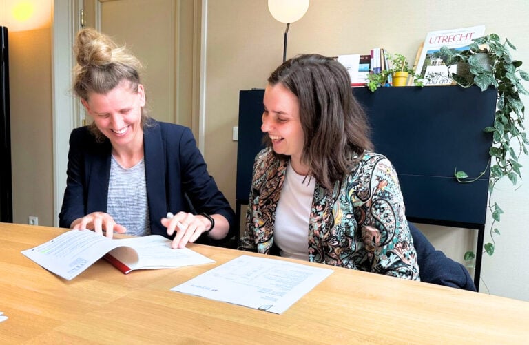 photo-of-author-and-partner_sitting_at_notaris_office_signing_after_getting_mortgage_from_expat_mortgages