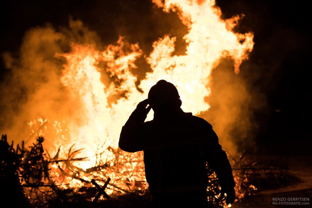 Silhouette-of-a-man-standing-in-front-of-the-bonfire