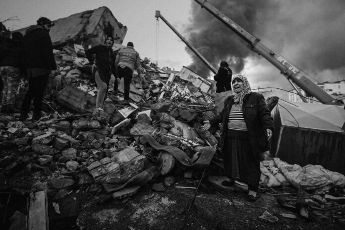 image of a woman crying surrounded by rubble of the Turkey earthquakes