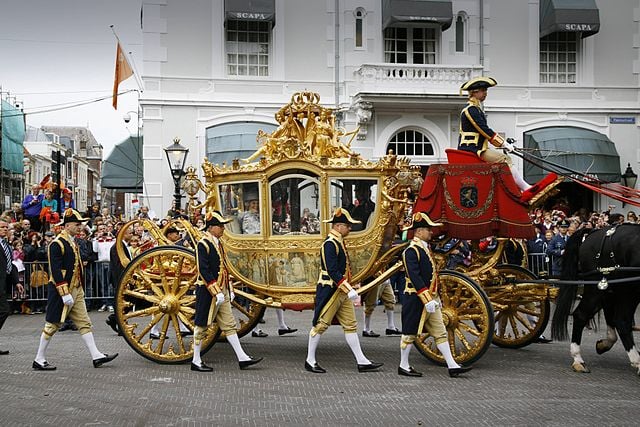 golden-carriage-surrounded-by-guards