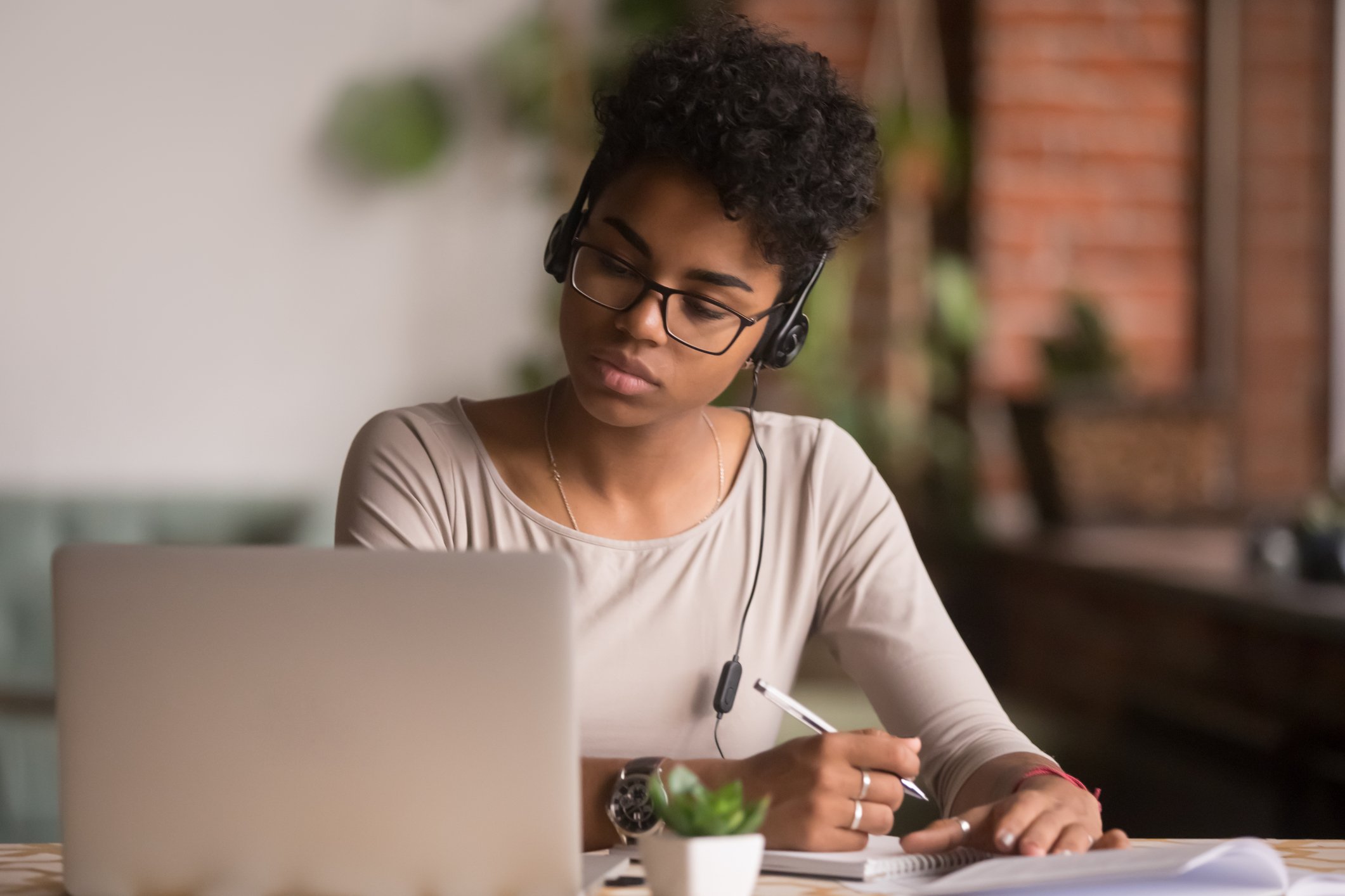 photo-of-woman-looking-at-laptop-attending-housing-webinar