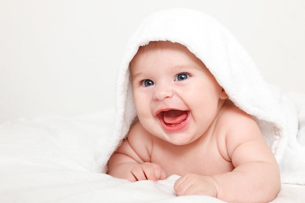 Laughing-baby-wrapped-in-white-towel