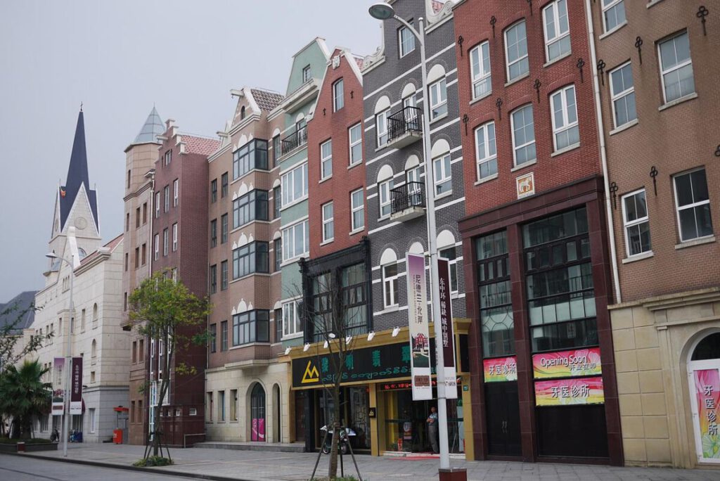 Photo-of-a street-in-Holland-Village-in-Shanghai-lined-with-Dutch-style-narrow-houses-in-shades-of-red-and-grey