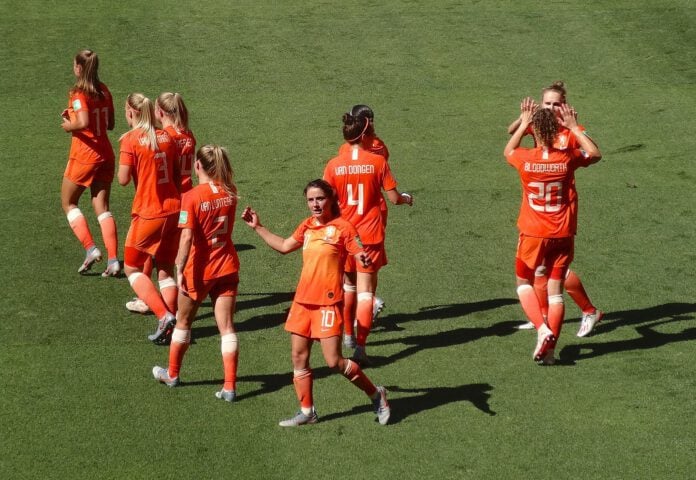 dutch-womens-football-team-wearing-bright-orange-uniforms-dispersed-on-football-playing-field