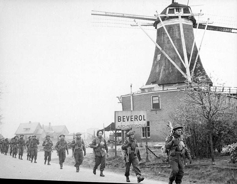 Canadian troops pass by a windmill close to Holten, 1945