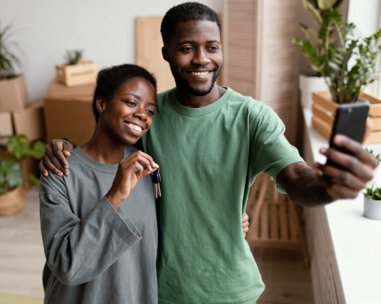 photo-of-couple-in-new-home-holding-keys-after-calculating-winning-offer-on-dream-house-Netherlands