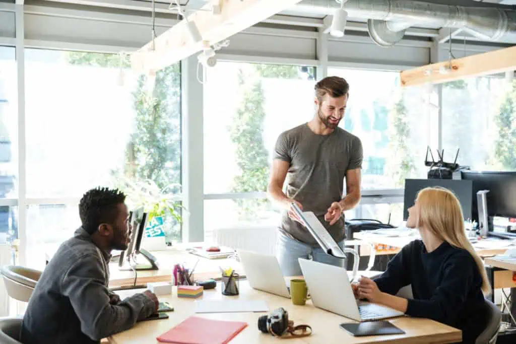 photo-of-man-pointing-at-paper-with-two-other-colleagues-in-Dutch-office-after-getting-sponsored-job-in-the-Netherlands