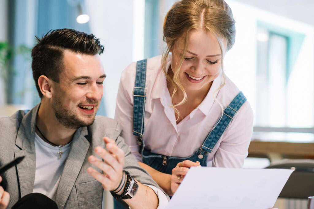 photo-of-woman-and-man-looking-at-Dutch-work-contract