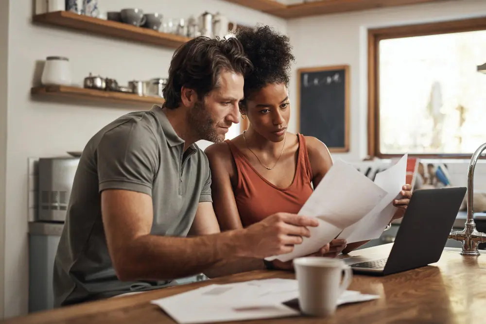 Photo-of-man-and-woman-sitting-at-desk-looking-at-Dutch-hospital-bill