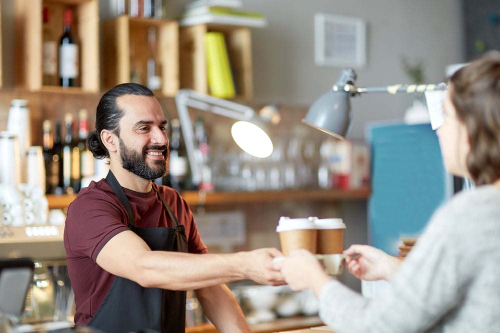 Customers-taking-and-thanking-barista-for-coffee-in-Dutch