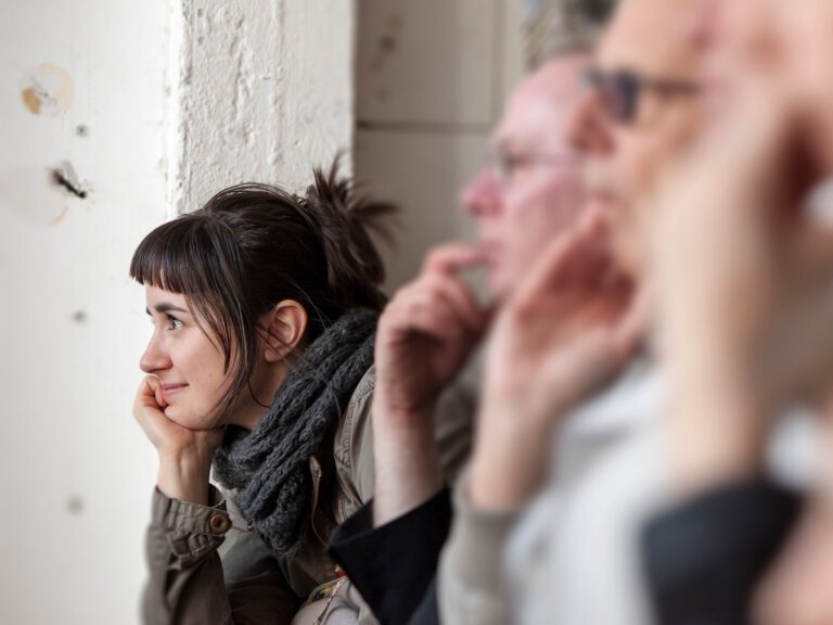 Woman watching a performance at ICAF 2023