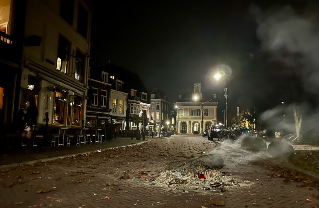 photo-of-burning-pile-of-fireworks-with-dutch-buildings-in-background