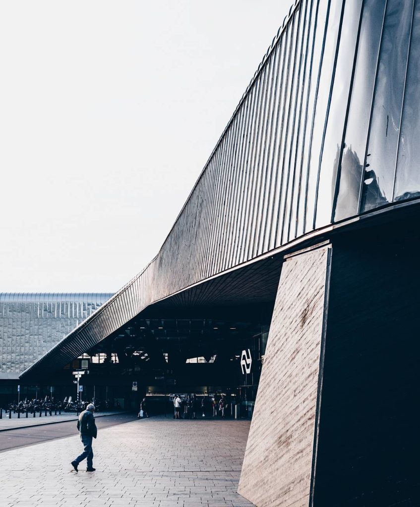 Photo-of-outside-of-Rotterdam-central-station-with-travelers-walking-in