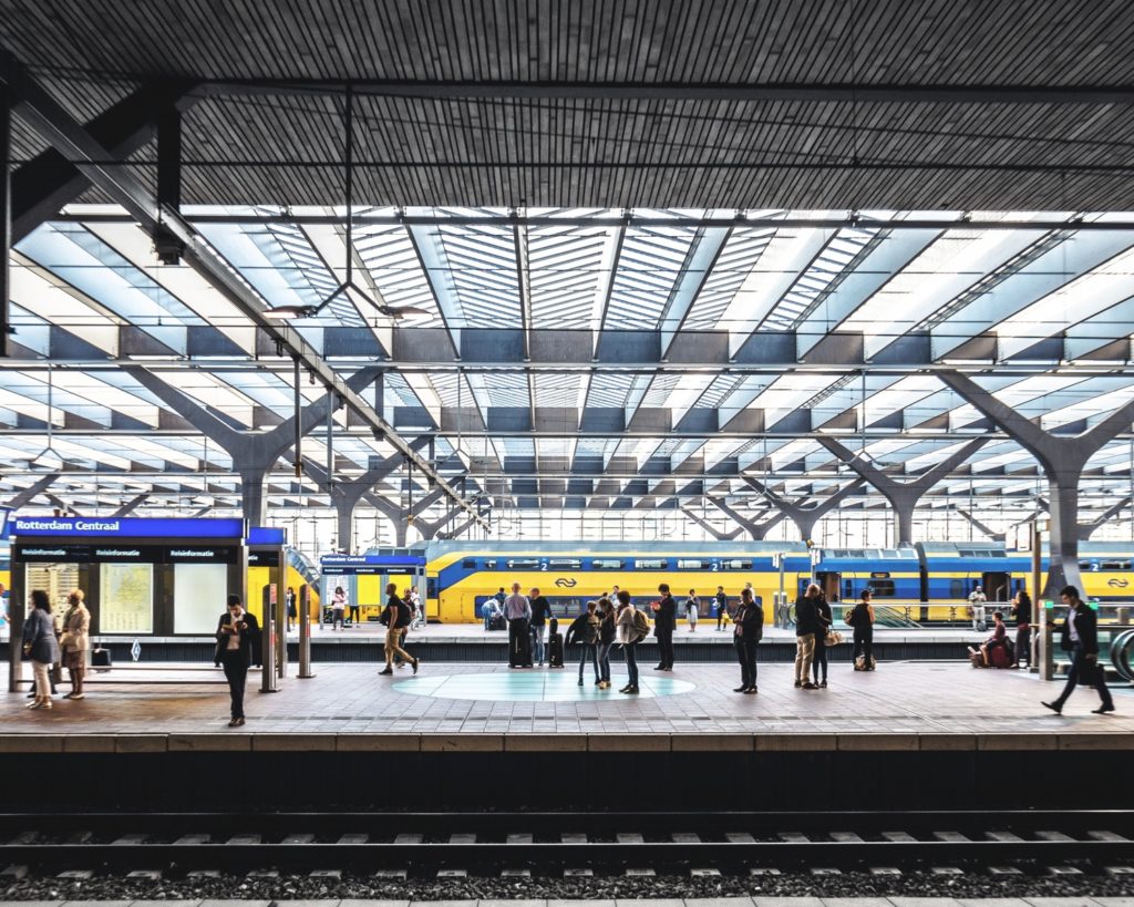 Photo-of-NS-train-inside-of-Rotterdam-Central-Station-with-passengers-waiting-on-platforms