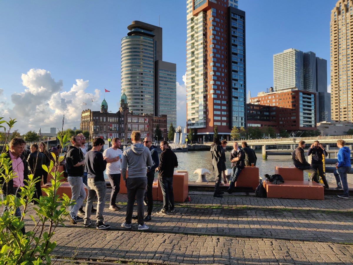 Image-of-people-standing-outside-having-a-party-next-to-the-river-in-the-afternoon