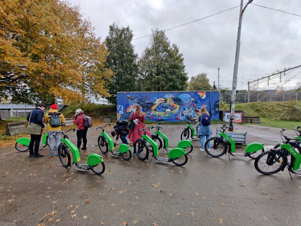 people-next-to-green-ebikes