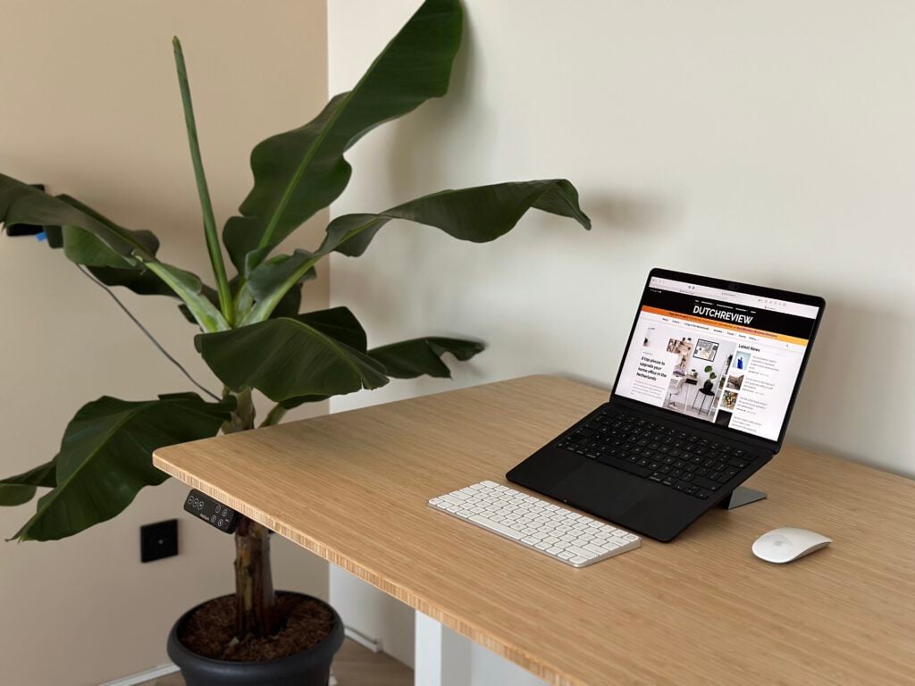 photo-of-desktop-with-laptop-keyboard-mouse-on-top-with-banana-plant-in-background