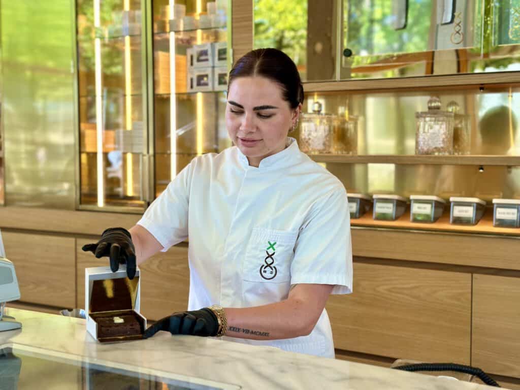 photo-of-female-budtender-in-coffeeshop-showing-chocolate-brownie-edible