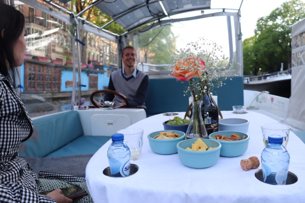 Photo-of-couple-enjoying-a-canal-cruise-with-romantic-tours-amsterdam