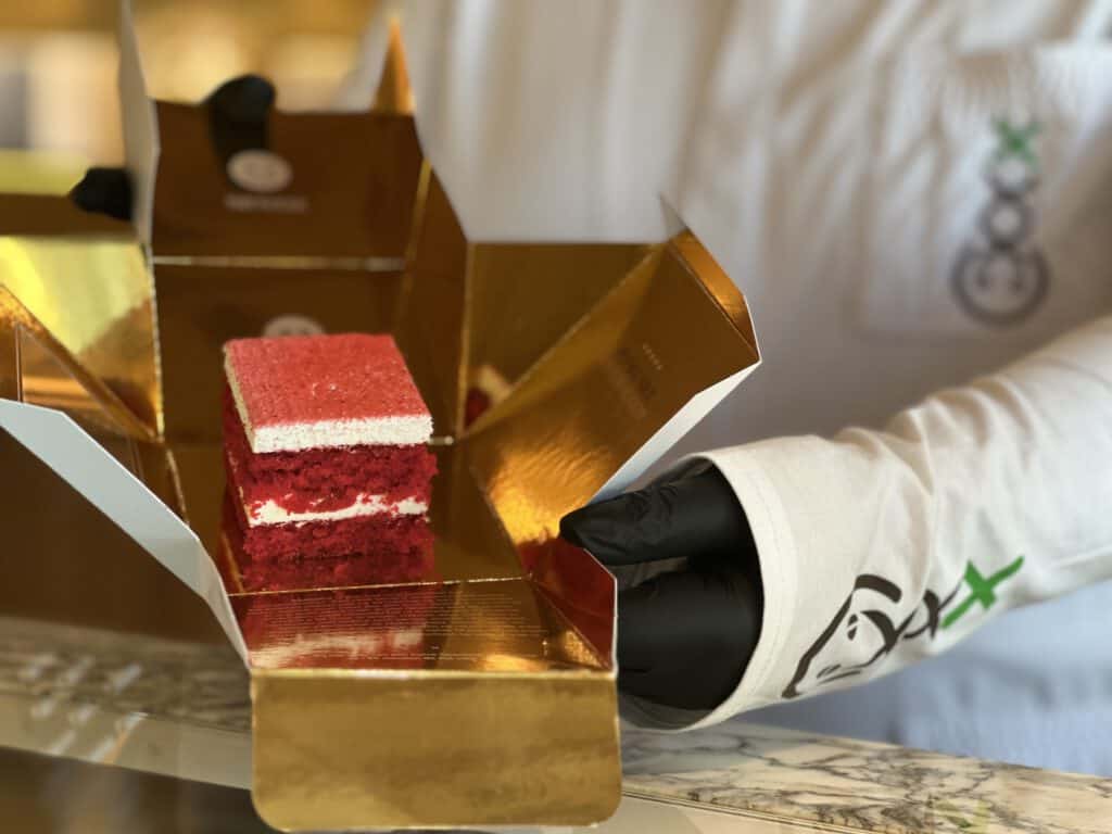 photo-of-budtender-holding-red-velvet-edible-in-gold-box