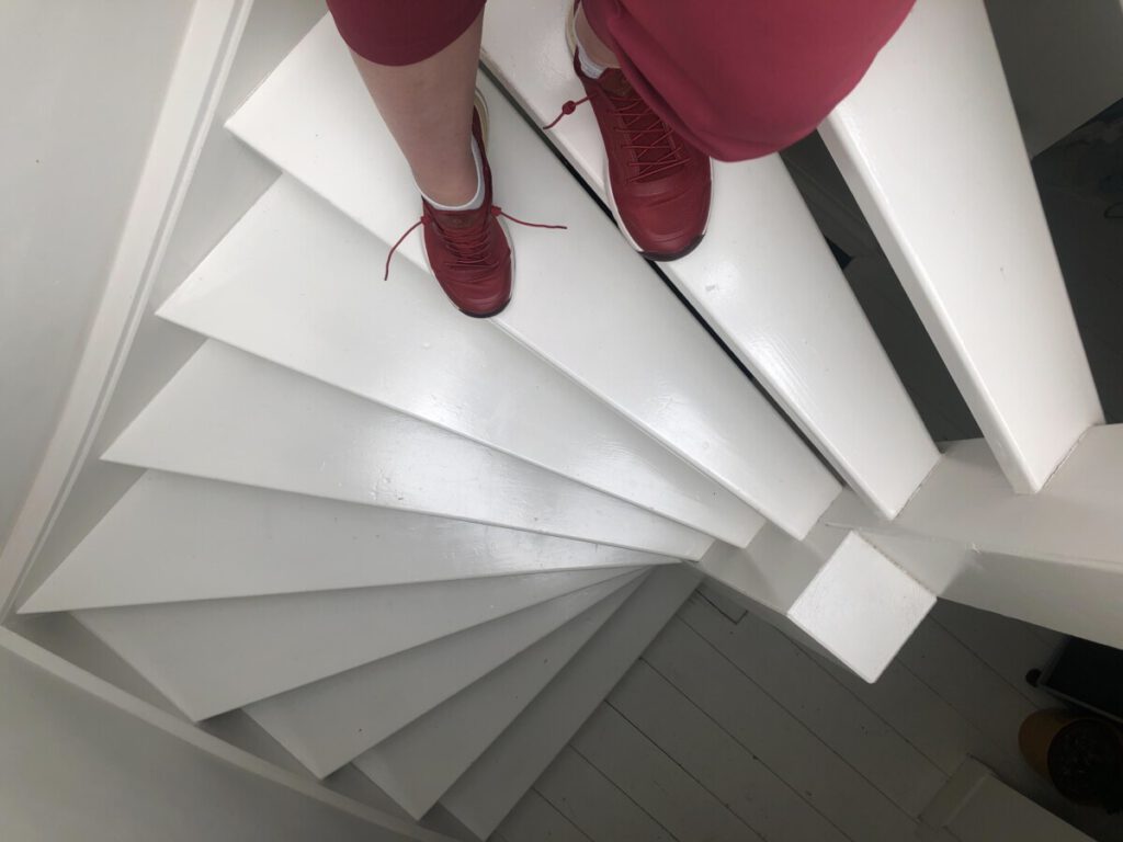 Photo-of-person-walking-down-steep-Dutch-staircase
