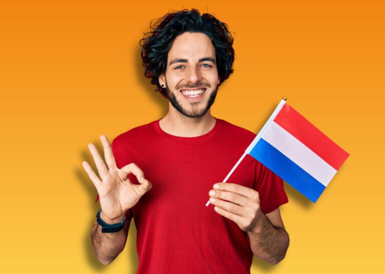 photo-of-smiling-man-holding-dutch-flag-and-making-ok-symbol-after-passing-dutch-inburgering-exams