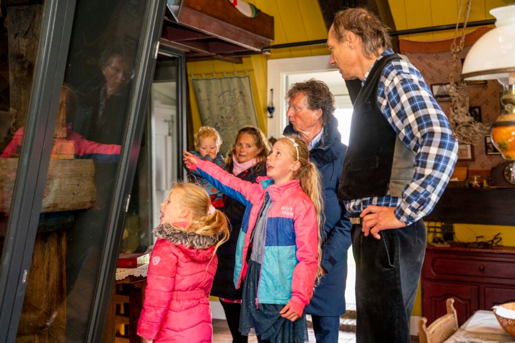 photo-of-children-and-adults-enjoying-tour-of-inside-blokweer-museum-mill-in-kinderdijk-things-to-do