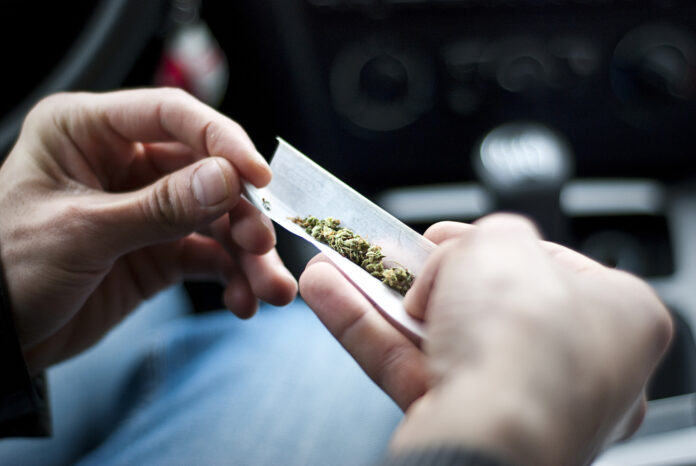 Person-rolling-weed-into-a-joint-clubs-amsterdam