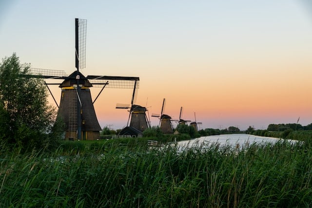 photo of windmills during the sunset in kinderdijk netherlands