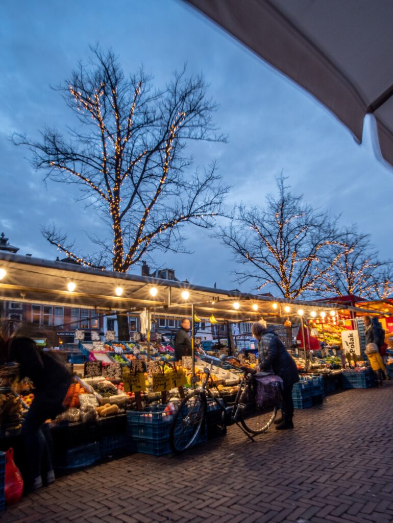 Leiden-street-market-at-night-with-lit-vegetable-stands