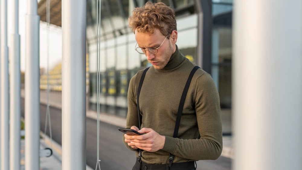 photo-of-man-looking-at-phone-outside