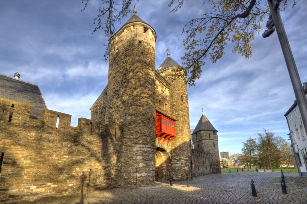 Historical city gate Helpoort with parts of the old city wall in Maastricht, Holland on Day trip to Maastricht