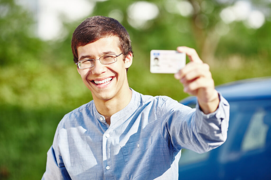 Man-holding-up-his-drivers-license-for-buying-a-car-in-the-netherlands